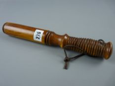 A 20th Century yew wood tipstaff with ring turned grip and leather lace strap, 28.5 cms long