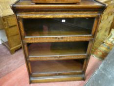 A Globe Wernicke style three shelf bookcase with plain glass panels and top hinges and with narrow
