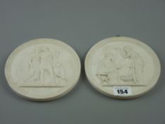 A pair of Royal Copenhagen Bas relief wall plaques depicting classical scenes, Royal Copenhagen,