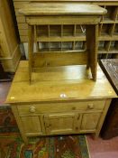 An antique stripped pine single drawer side cabinet with single central door storage space below,