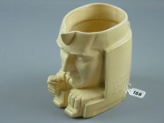 A rare Ashstead potter's character jug, sandstone colour Art Deco form jug of a first edition