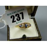 A believed eighteen carat gold dress ring with three sapphires and two diamonds, 3.6 grms