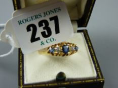 A believed eighteen carat gold dress ring with three sapphires and two diamonds, 3.6 grms
