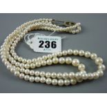 A double strand pearl necklace of graduated pearls with silver clasp, 34 grms gross