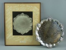 A silver salver and photograph - a circular silver salver on three hoof supports with wavy shell