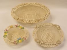 THREE BELLEEK BASKETS in typical form with applied flowers to the border comprising a large four-