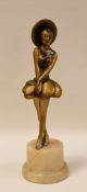 A PAINTED METALLIC ART DECO FIGURE on a marble base (repaired), 27cms high