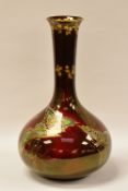 DEVON 'SYLVAN LUSTRINE' POTTERY BOTTLE-VASE in crimson with gilded and coloured insects, 24cms high