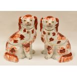 A GOOD PAIR OF STAFFORDSHIRE RED AND WHITE SEATED DOGS with gilded collars, padlocks and leads
