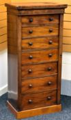 A VICTORIAN MAHOGANY WELLINGTON CHEST, having seven graduated drawers and turned pull knobs,