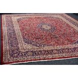 A LARGE RED GROUND PERSIAN KASHAN CARPET, multi-coloured traditional design, 384 x 296 cms