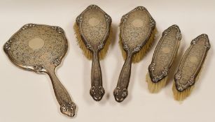 FOUR PIECE SILVER DRESSING-TABLE SET comprising hand mirror, a pair of hair-brushes and a clothes-