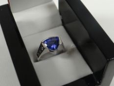 A TRILLION CUT TANZANITE, DIAMOND & WHITE GOLD RING