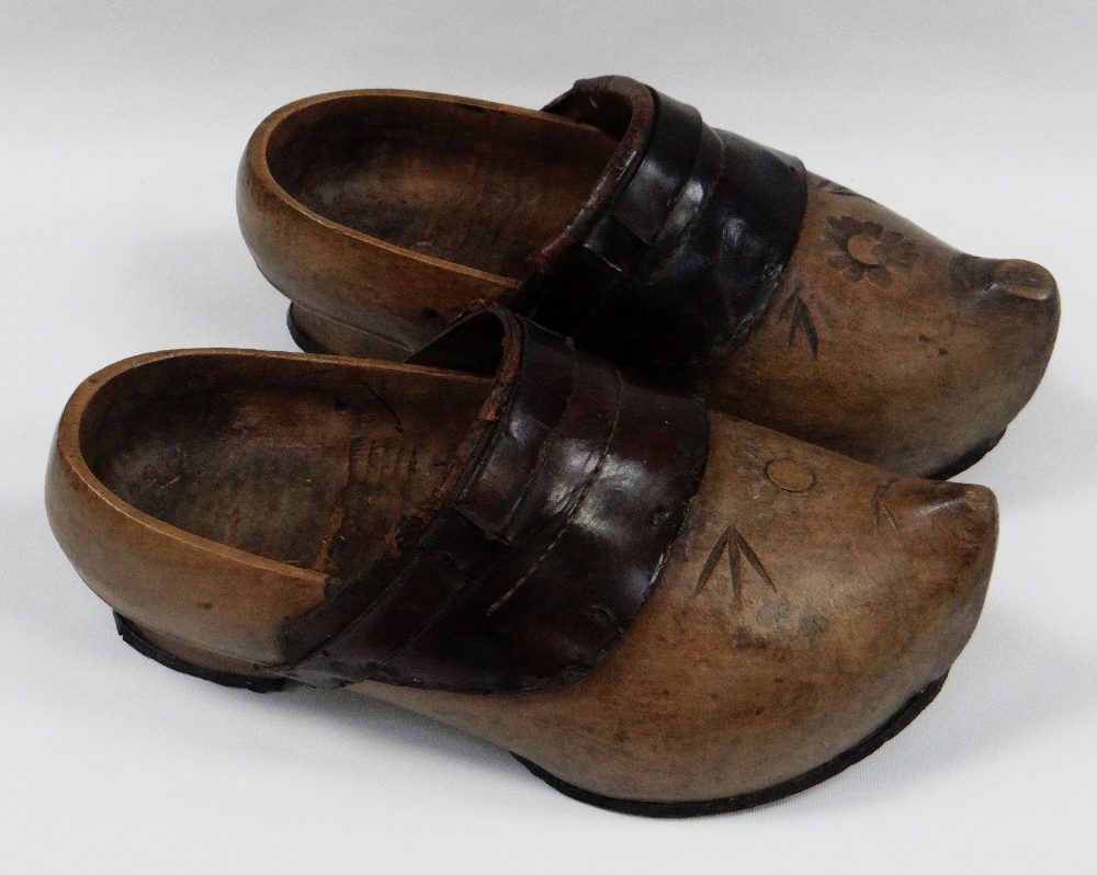 A PAIR OF WOODEN & LEATHER NORTHERN EUROPEAN CLOGS with floral carving, 31cms long BBC Bargain Hunt