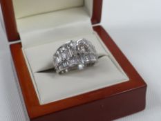 DIAMOND & 18ct WHITE GOLD RING composed of a raised brilliant-cut diamond over three rows of