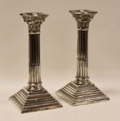PAIR OF SILVER CORINTHIAN COLUMN CANDLESTICK-HOLDERS, on stepped square bases, Birmingham 1912,