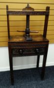 A NINETEENTH CENTURY OAK PRESS TABLE with carved single door to the front bearing turned knobs,