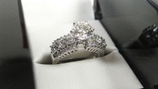 BRILLIANT CUT DIAMOND SOLITAIRE & DIAMOND SHOULDER 18ct WHITE GOLD RING with raised solitaire over