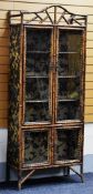 EARLY TWENTIETH CENTURY BAMBOO DISPLAY CABINET with four glazed doors, the shelved interior with