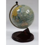A CHAD VALLEY TINPLATE TERRESTIAL GLOBE, the faux-wood stand with printed detail, 28cms high,