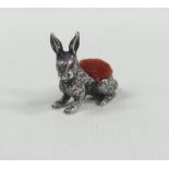 A SMALL NOVELTY SILVER PIN-CUSHION IN THE FORM OF A SEATED RABBIT with realistic fur detail, 3cms