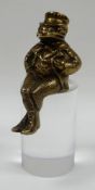 A SOLID BRASS MASCOT OR FINIAL IN THE FORM OF A SEATED TOAD wearing suit and waistcoat in the