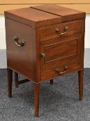 VANITY CABINET WITH BRASS FITTINGS on raised tapered supports, the top splitting into hinged lids