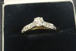 A 14k YELLOW GOLD DIAMOND RING having a centre diamond of 0.45cts (visual estimate) and five