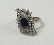 A DIAMOND & SAPPHIRE CLUSTER RING of abstract form with centre sapphire and approximately 40