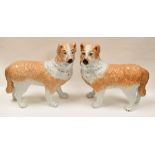 A PAIR OF WHITE AND BROWN STAFFORDSHIRE DOGS IN STANDING POSITION with painted faces, 29cms