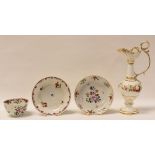 UNUSUAL FLORAL DECORATED EWER TOGETHER WITH TWO TEA BOWL SAUCERS AND A SINGLE CUP, the body of the