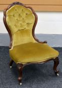 A QUEEN ANNE STYLED BUTTON-BACKED BEDROOM CHAIR with foliate carving to the top with ball and claw