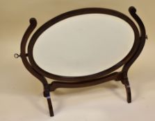 AN OVAL MAHOGANY TOILET MIRROR, 56 x 65 cms