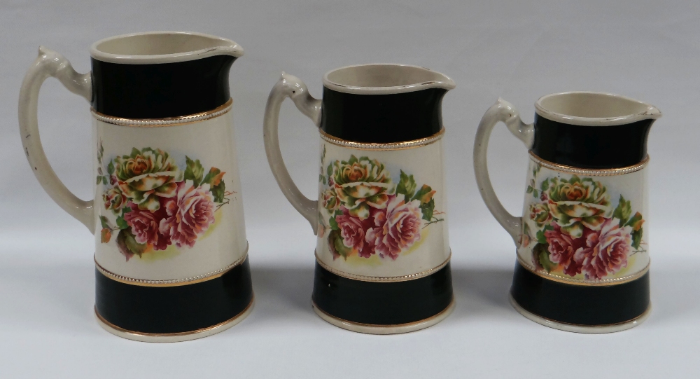 A GRADUATED TRIO OF STAFFORDSHIRE POTTERY JUGS COMMEMORATING THE ALLIED FORCES OF WORLD WAR I,