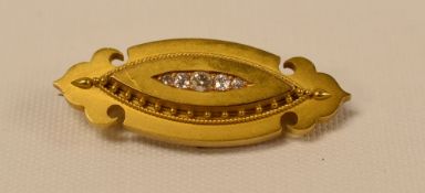 A MARQUISE SHAPED FIVE DIAMOND BROOCH, in a believed gold (unmarked) setting with centre row of