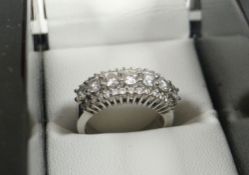 A HALF-HOOP DIAMOND & 18ct WHITE GOLD ETERNITY RING composed of seven brilliant cut diamonds and two