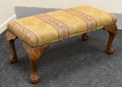 A LARGE UPHOLSTERED FOOTSTOOL with ball and claw feet, 42 x 105 x 50 cms