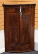 A MAHOGANY BOW-FRONTED HANGING CORNER CUPBOARD with inlay to doors and top and three small