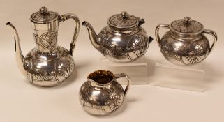A FOUR-PIECE AMERICAN SILVER TEA-SET, decorated with raised stylised flowers and geometric motifs,