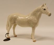 A BESWICK STANDING DAPPLED GREY HORSE 'COMMENARA CHAMPION - TERESE OF LEAN' still with Beswick
