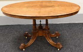 AN OVAL BURR WALNUT TILT-TOP DINING TABLE on four feet, 135 x 100 cms