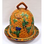 A NINETEENTH CENTURY MINTON MAJOLICA STILTON DISH AND COVER modelled as a beehive and decorated with