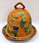 A NINETEENTH CENTURY MINTON MAJOLICA STILTON DISH AND COVER modelled as a beehive and decorated with