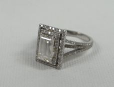 EMERALD-CUT DIAMOND & 18ct WHITE GOLD RING with diamonds to the split shoulders and surrounding