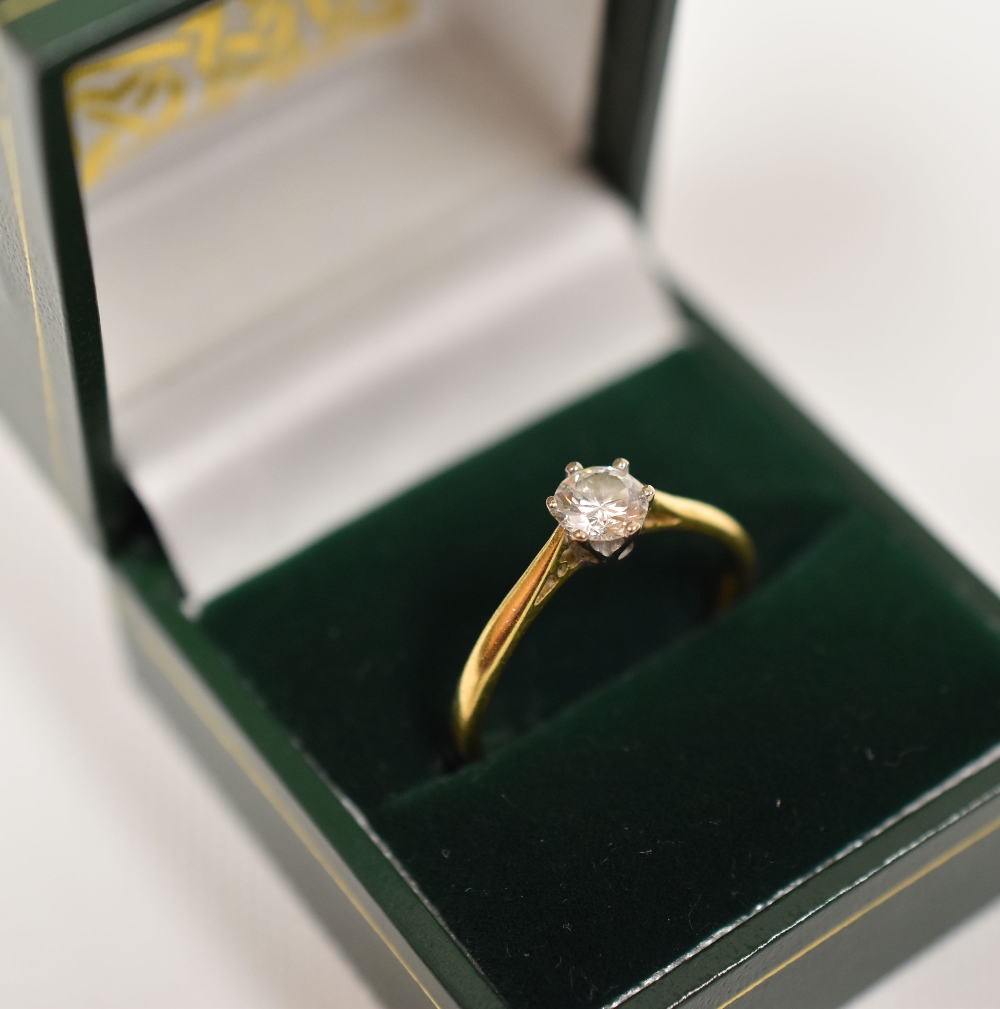 DIAMOND SOLITAIRE RING with single brilliant cut diamond, claw set in 18ct yellow gold, London,