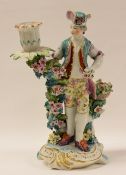 ATTRIBUTED TO DERBY PORCELAIN FIGURE OF A GARDENER standing on a scroll base with gilding