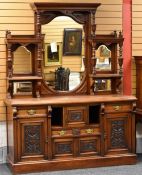 AN EDWARDIAN MAHOGANY MIRROR-BACK SIDEBOARD the base formed by carved panels, two cupboard doors and