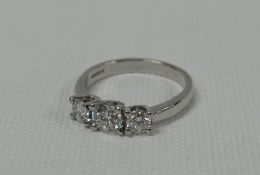 A PLATINUM THREE STONE DIAMOND RING the round brilliant centre diamond 0.53ct (VVS2) flanked by