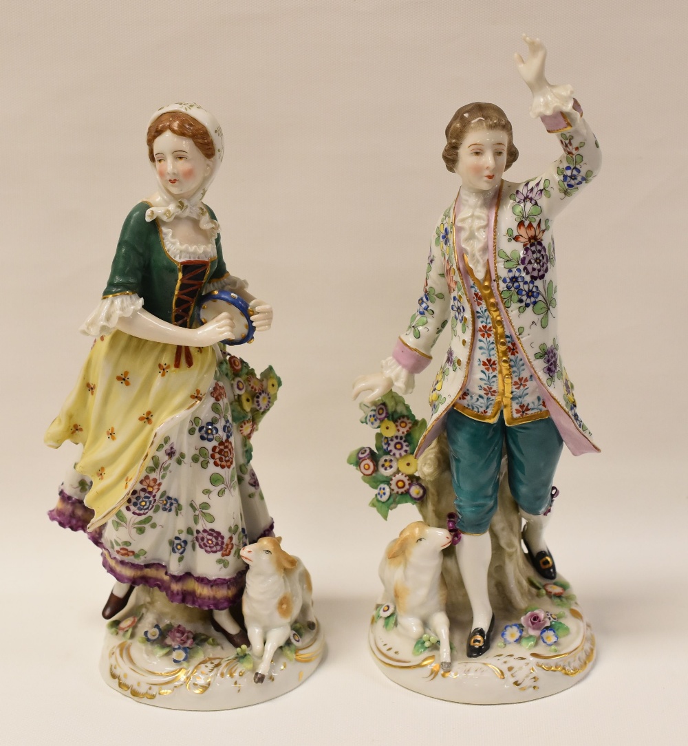 A PAIR OF CONTINENTAL PORCELAIN REGENCY-STYLE FIGURINES each with floral clothing and with lambs