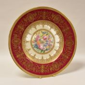 A MINTON DISPLAY PLATE having a crimson and gilded border and with centre painted flower display,